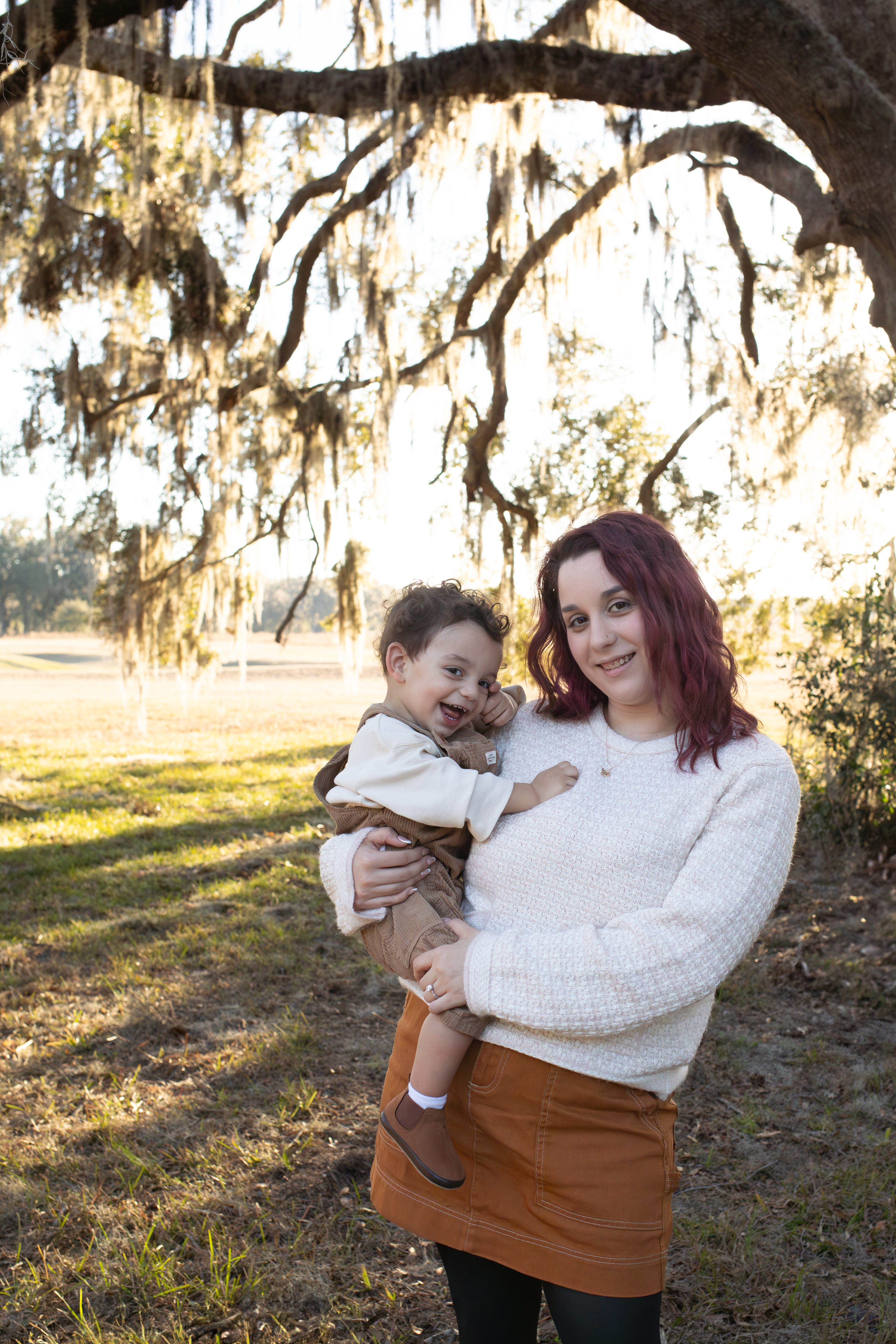 Abbie with her son under an oak tree